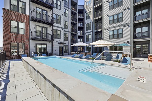 Infinity-edge pool at The Navigator Apartments with luxurious seating and scenic views