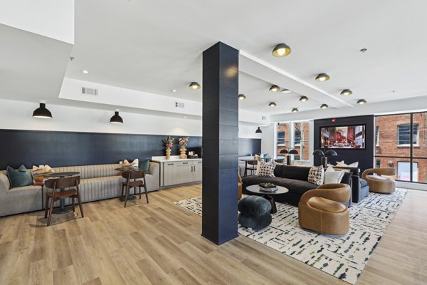 Stylish clubhouse with modern bar area at The Navigator Apartments, perfect for social gatherings and leisure activities