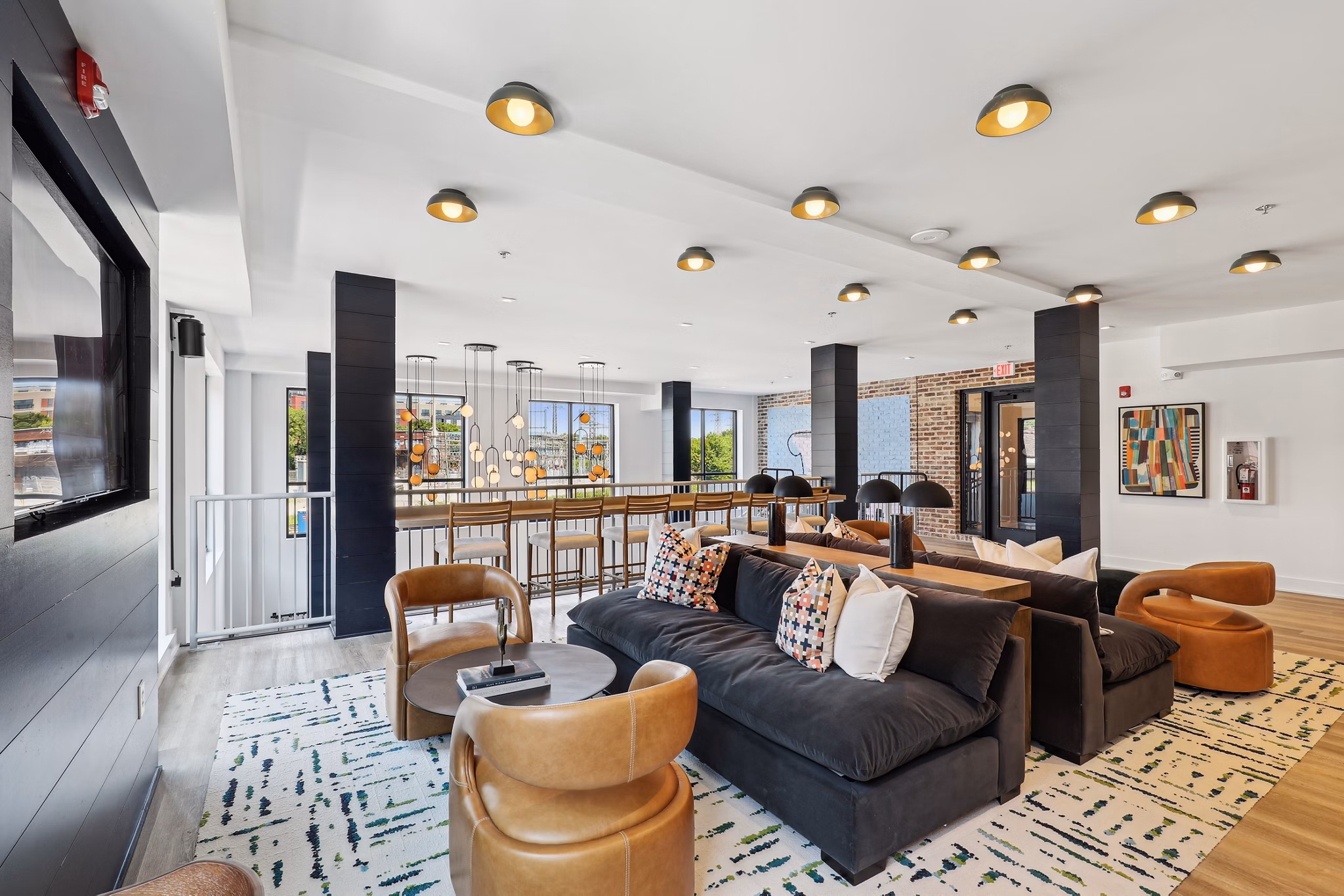 Clubhouse with modern seating and game area at The Navigator Apartments