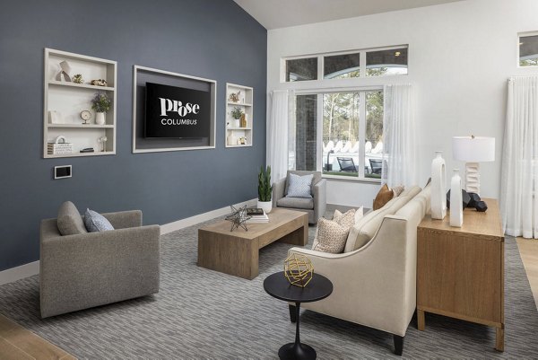 Modern clubhouse with stylish seating and game area at Prose Columbus Apartments for social gatherings and relaxation