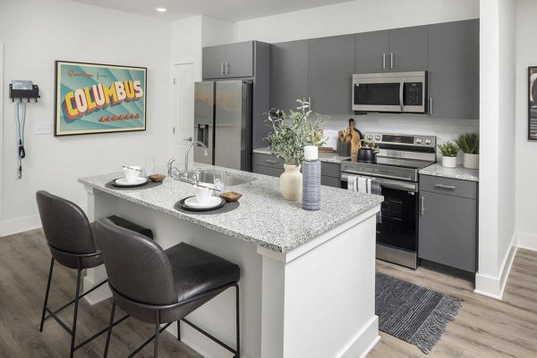 Modern kitchen featuring sleek appliances and island at Prose Columbus Apartments