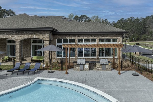 Inviting outdoor pool at Prose Columbus Apartments with palm trees and lounge chairs