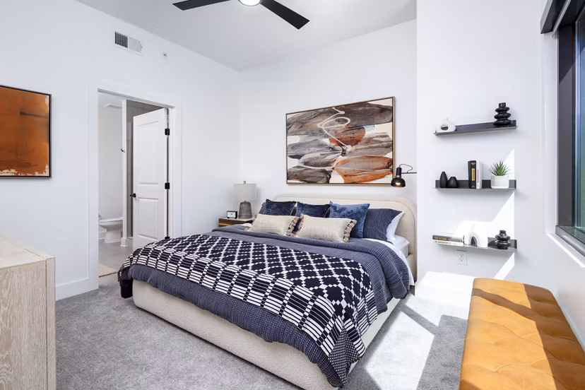 Cozy bedroom with elegant decor at The Grace Residences Apartments featuring luxurious bedding and ample natural light