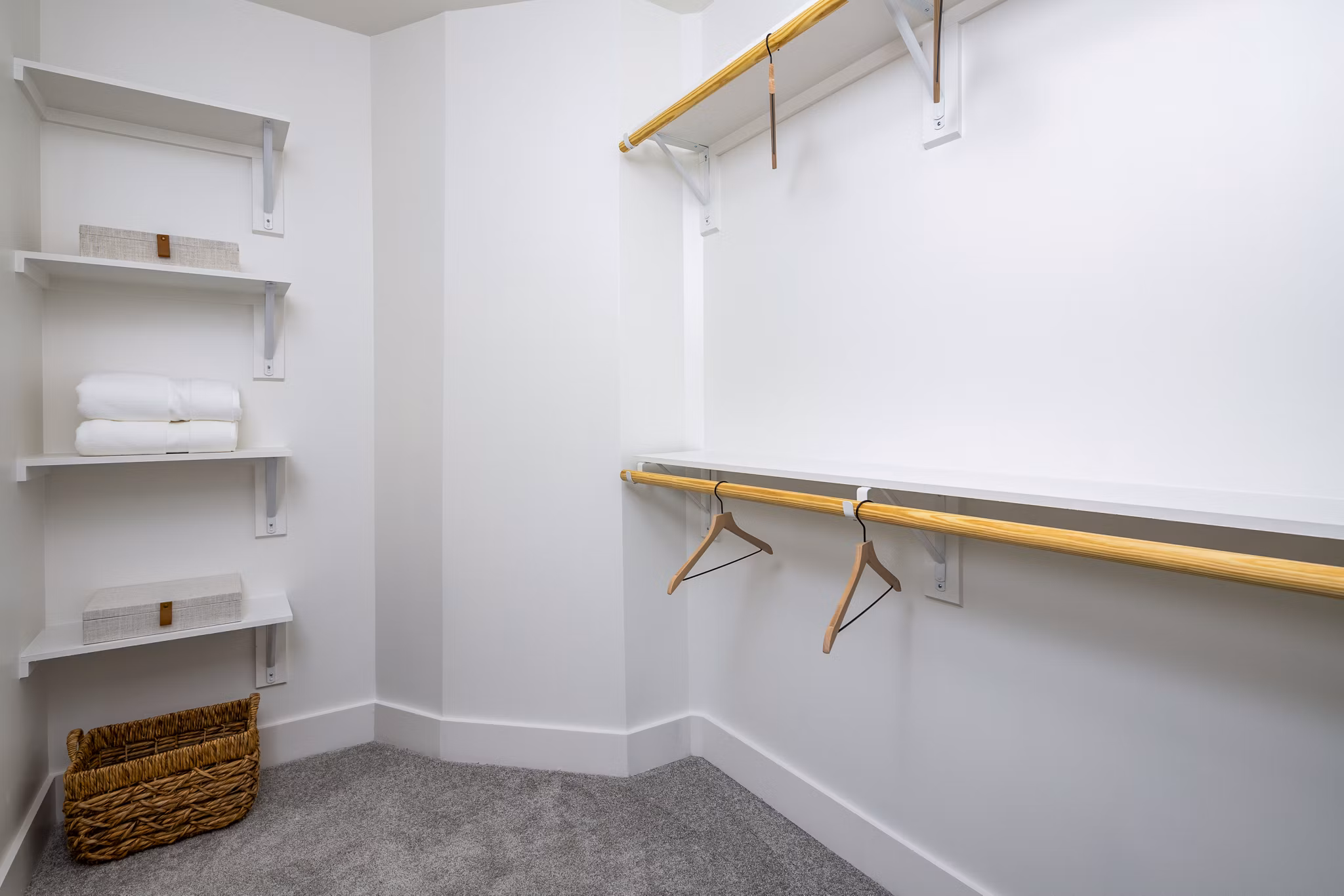 Walk-in closet in a modern bedroom at The Grace Residences Apartments, luxury living with ample storage solutions