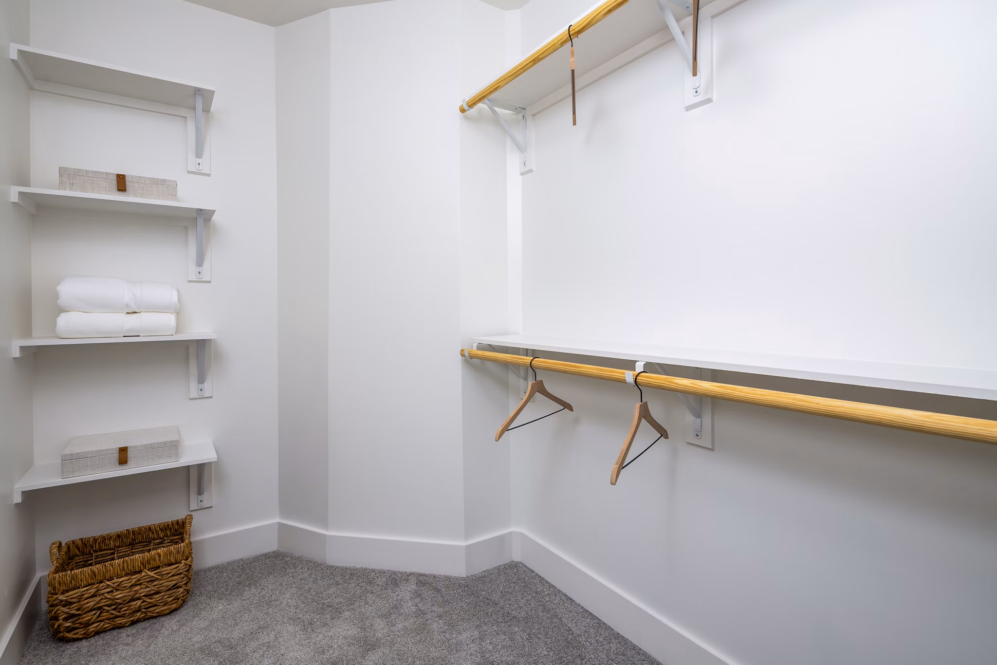 Walk-in closet in a modern bedroom at The Grace Residences Apartments, luxury living with ample storage solutions