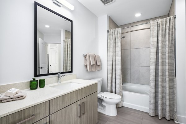 Bathroom featuring modern fixtures and marble countertops in The Grace Residences apartments