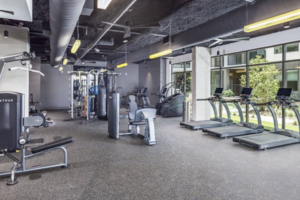 Modern fitness center with state-of-the-art equipment at The Grace Residences Apartments, offering premium workout facilities for residents