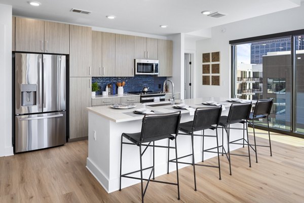 Modern kitchen with stainless steel appliances in The Grace Residences Apartments