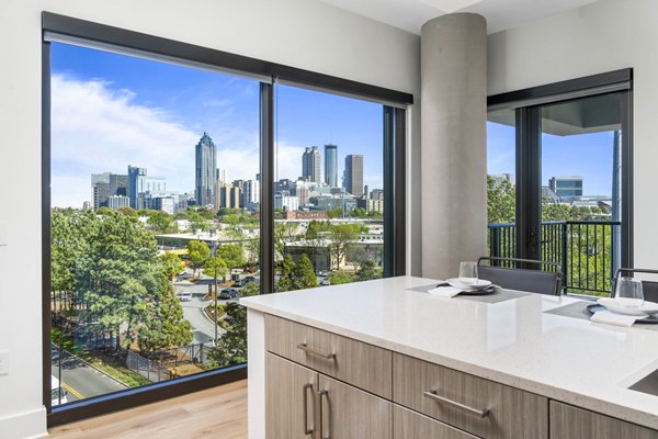 Modern kitchen with marble countertops and stainless steel appliances at The Grace Residences Apartments