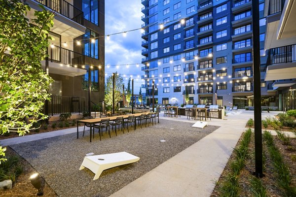 Grill area with seating on a patio at The Grace Residences