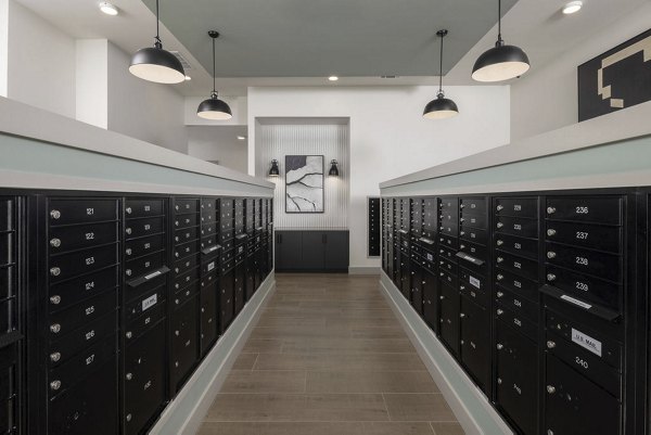 Mail room at Prose LaGrange Apartments featuring package lockers and community notice board