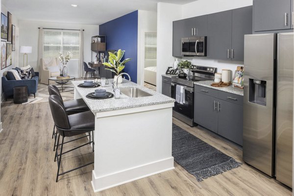 Modern kitchen with stainless steel appliances and sleek countertops at Prose LaGrange Apartments
