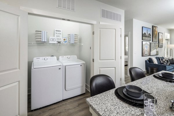 Laundry room with modern appliances at Prose LaGrange Apartments luxury living