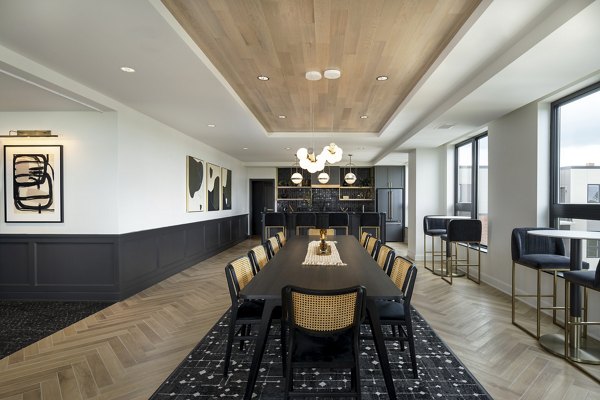 Clubhouse meeting facility with modern seating and projector at Vyne on Haven Apartments, ideal for community gatherings and events