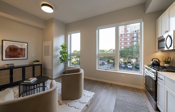 Modern living room with sleek furnishings and large windows at Vyne on Haven Apartments