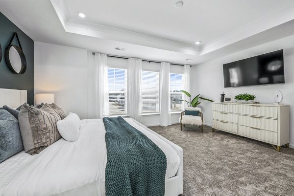 Cozy bedroom with modern decor at Wayford at Pringle Towns Apartments