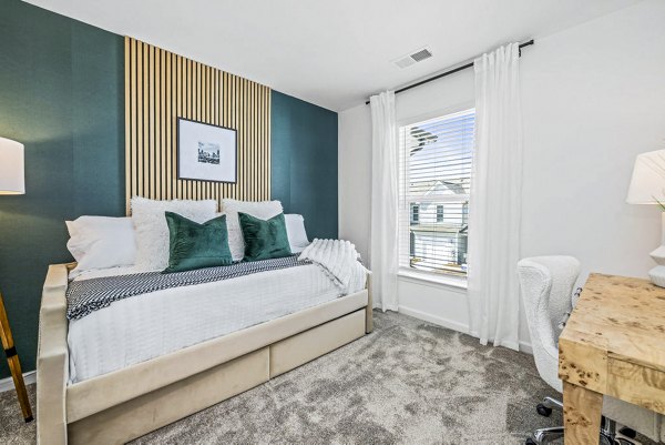 Cozy bedroom with modern decor at Wayford at Pringle Towns Apartments featuring luxury living amenities for stylish comfort