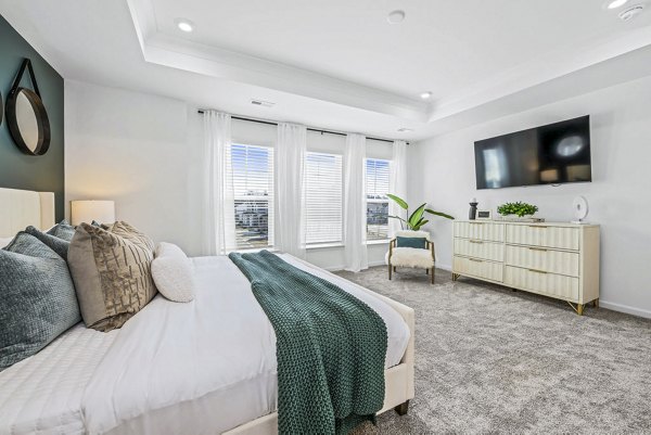 Wayford at Pringle Towns Apartments: Cozy bedroom with modern furnishings and ample natural light, perfect for luxury living
