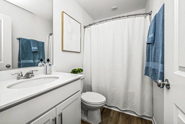 Bathroom with modern fixtures and marble countertops at Wayford at Pringle Towns Apartments