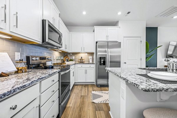 Spacious kitchen with modern appliances at Wayford at Pringle Towns Apartments, luxury living by Greystar