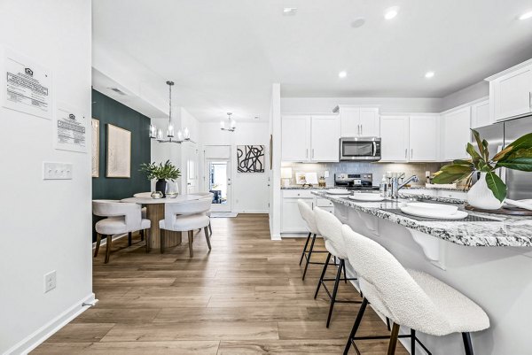 Wayford at Pringle Towns: Modern kitchen with stainless steel appliances and granite countertops in luxury apartments
