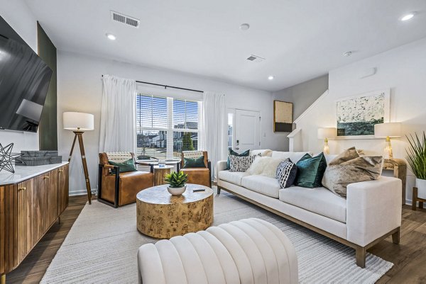 Modern living room with chic decor and ample natural light at Wayford at Pringle Towns Apartments, a luxury apartment community