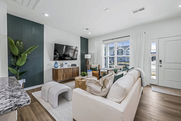 Spacious living room with modern decor and large windows in Wayford at Pringle Towns Apartments