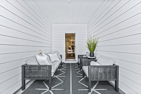 Cozy patio at Wayford at Pringle Towns Townhomes featuring outdoor seating and greenery