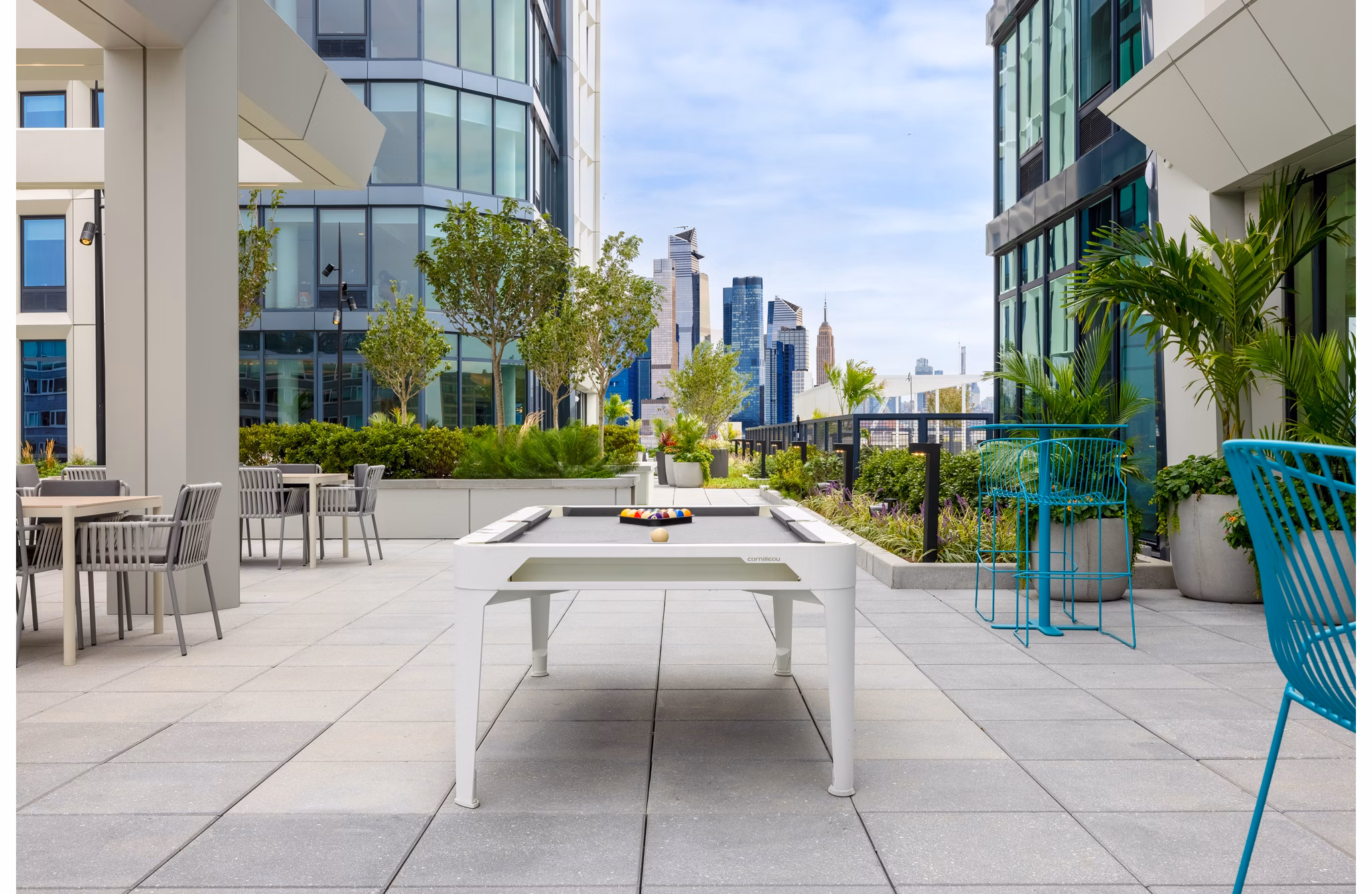 Modern outdoor patio with stylish seating at Hoboken Point Apartments, perfect for relaxing and socializing in a luxury setting