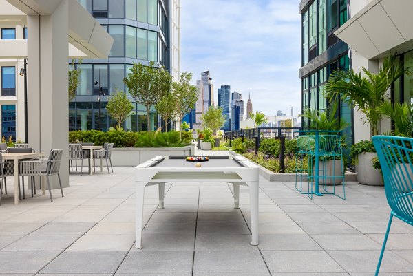 Modern outdoor patio with stylish seating at Hoboken Point Apartments, perfect for relaxing and socializing in a luxury setting