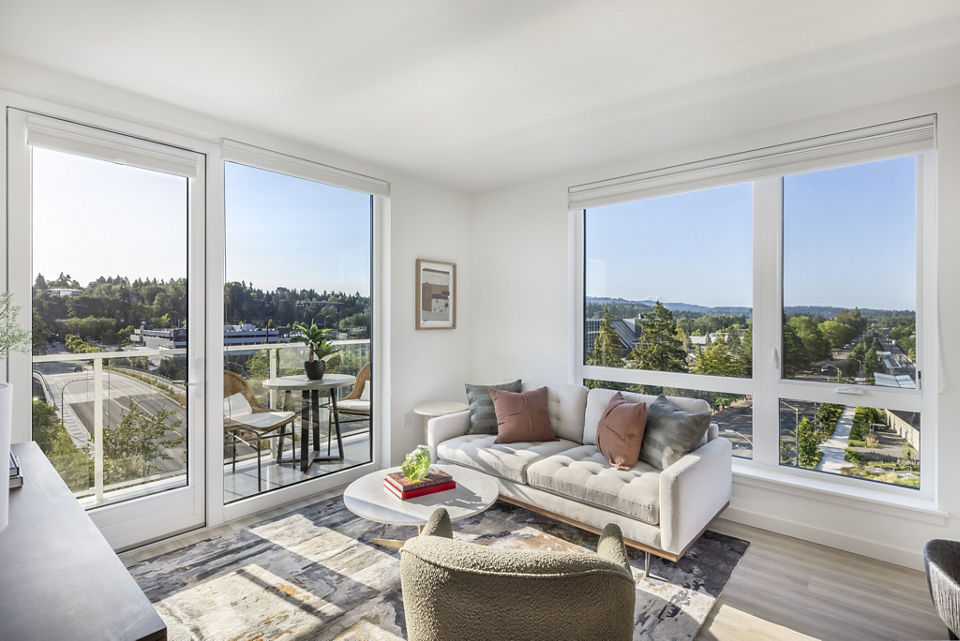 Stylish living room with modern decor and ample natural light at Broadstone Savoie Apartments