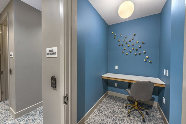 Modern business center with sleek workstations in clubhouse at Alta Washington Apartments