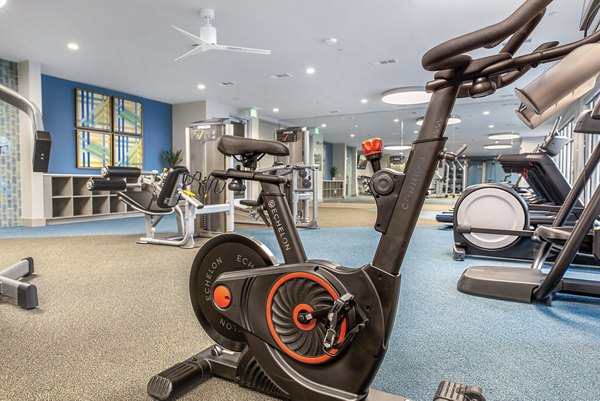 Fully-equipped fitness center at Alta Washington Apartments with modern workout machines and open workout space