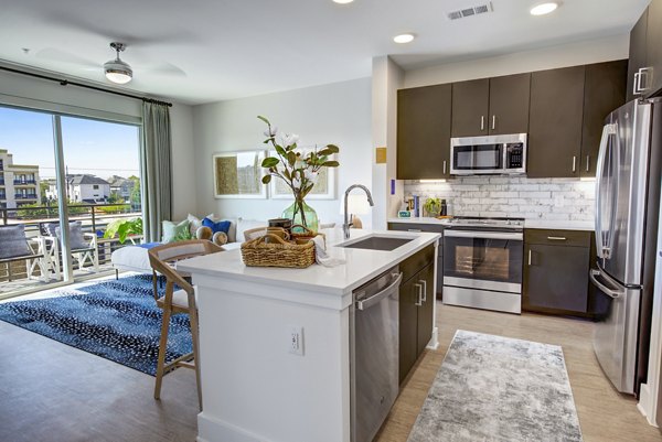 Modern kitchen with stainless steel appliances in Alta Washington Apartments
