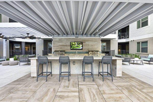 Outdoor grill and patio area at Crosstown Phoenix East Apartments, ideal for social gatherings and relaxation
