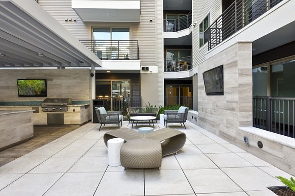 Grill area with modern patio seating at Crosstown Phoenix East Apartments, perfect for outdoor gatherings and relaxation