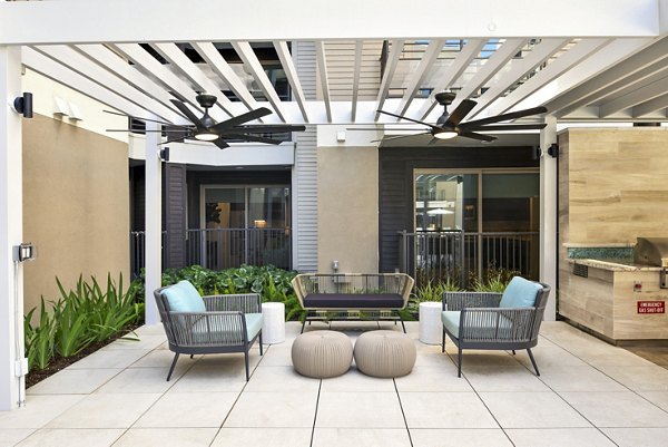 Patio with modern outdoor seating at Crosstown Phoenix East Apartments, ideal for relaxation and socializing