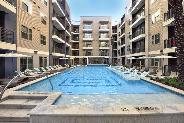 Rooftop pool with loungers at Alta Washington Apartments with city views