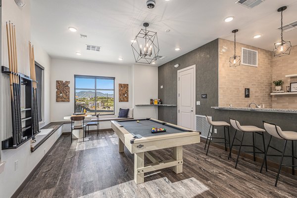 Stylish clubhouse with modern seating at The Preserve at Mesa Creek Apartments in serene surroundings