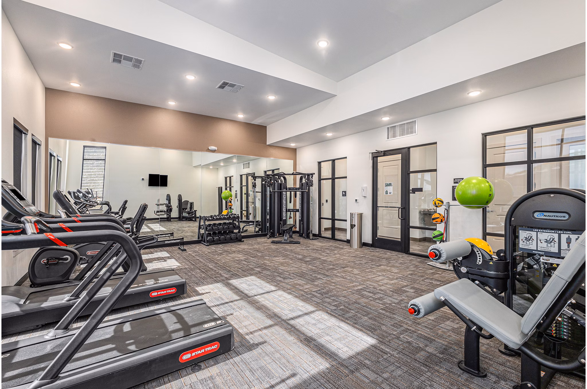 Fitness center with modern equipment at The Preserve at Mesa Creek Apartments, offering a state-of-the-art workout environment for residents