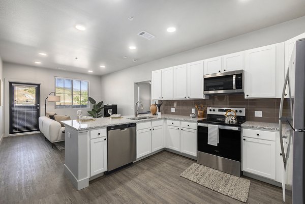 Kitchen featuring granite countertops and stainless steel appliances at The Preserve at Mesa Creek Apartments