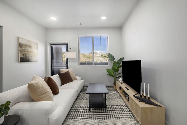 Modern living room with elegant furnishings at The Preserve at Mesa Creek Apartments, featuring comfortable seating and stylish decor