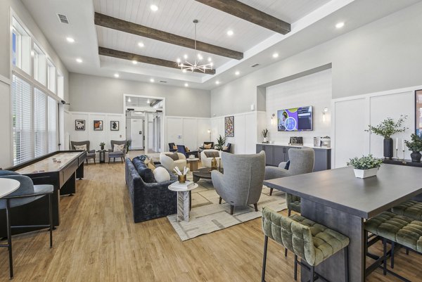Elegant clubhouse lobby with contemporary furnishings at Advenir at Mallory Lake Apartments, featuring ambient lighting and luxurious seating areas