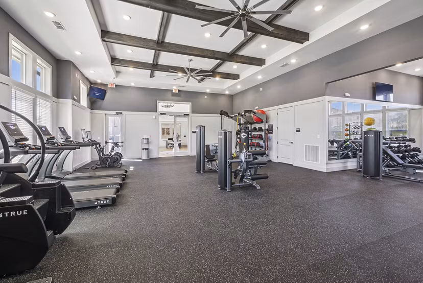 Modern fitness center equipped with state-of-the-art machines at Advenir at Mallory Lake Apartments