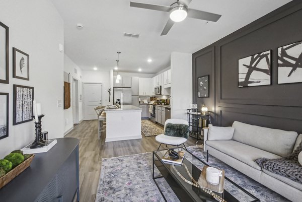 Spacious living room with modern decor and lake views in Advenir at Mallory Lake Apartments, a Greystar luxury community