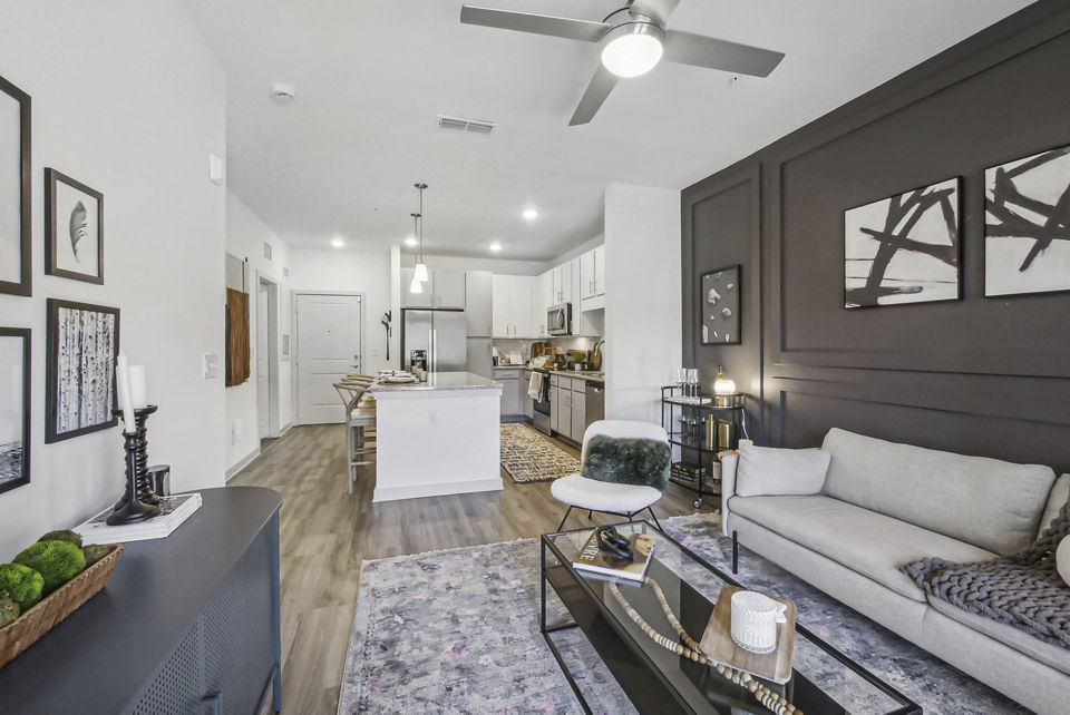 Spacious living room with modern decor and lake views in Advenir at Mallory Lake Apartments, a Greystar luxury community
