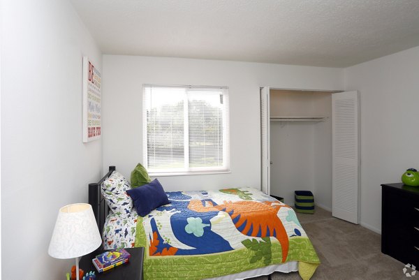 Cozy bedroom with modern furnishings at The Retreat Northwest Apartments, Greystar luxury living