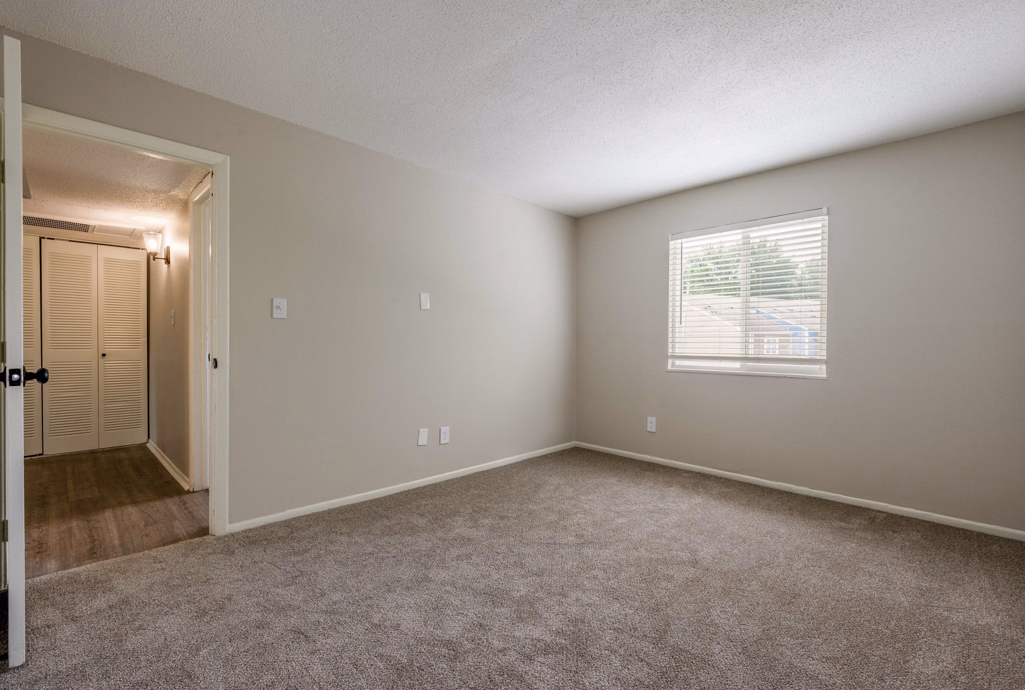 Cozy bedroom with natural light at The Retreat Northwest Apartments, featuring modern design for comfortable living