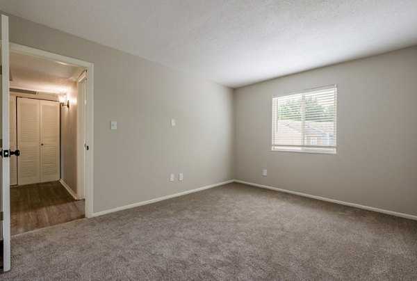 Cozy bedroom with natural light at The Retreat Northwest Apartments, featuring modern design for comfortable living