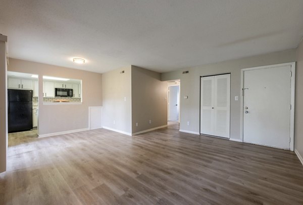 Cozy bedroom with plush carpeting and ambient lighting in The Retreat Northwest Apartments